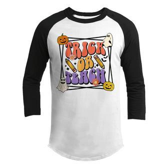 Groovy Trick Or Teach Funny School Halloween Teacher Life Youth Raglan Shirt - Thegiftio UK