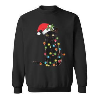 Santa Black Cat Tangled Up In Christmas Tree Lights Holiday Sweatshirt - Seseable
