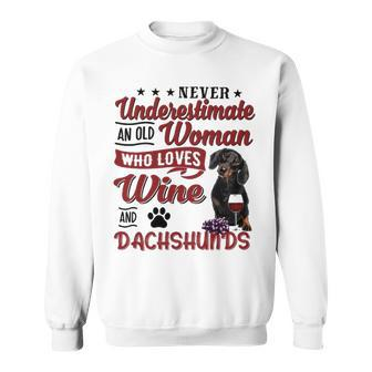 Never Underestimate An Old Woman Who Loves Wine And Dachshunds Sweatshirt - Thegiftio UK