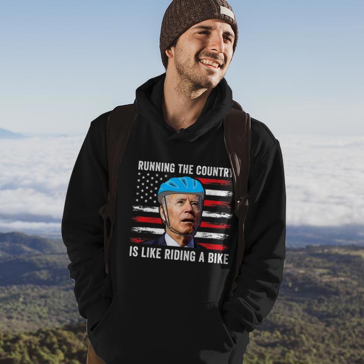 Joe Biden Falling Off His Bicycle Funny Biden Falls Off Bike America Flag Hoodie Lifestyle