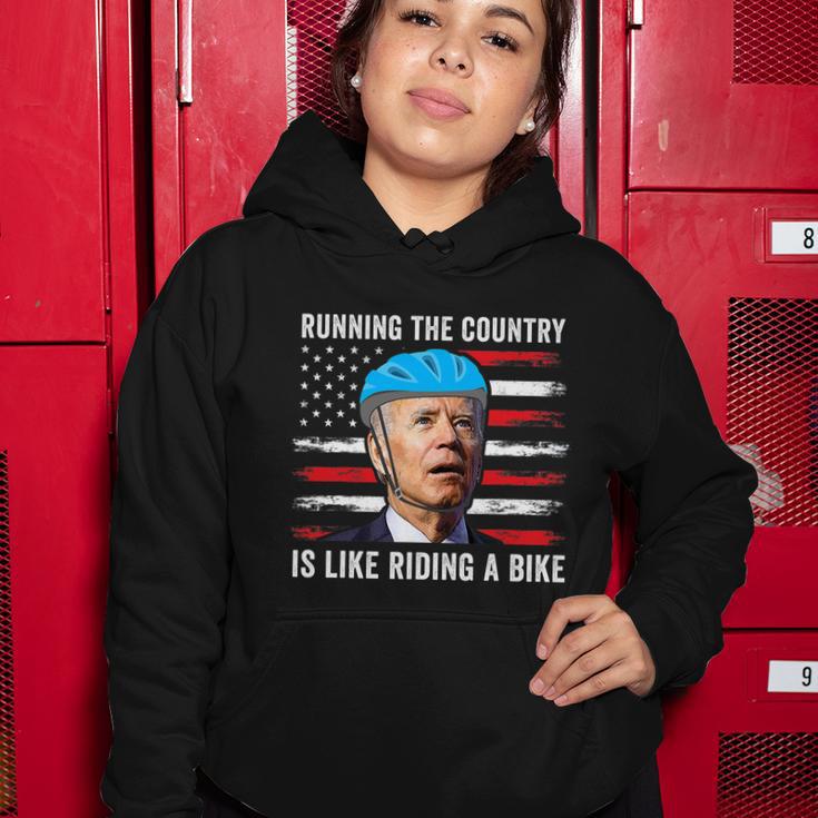 Joe Biden Falling Off His Bicycle Funny Biden Falls Off Bike America Flag Women Hoodie Unique Gifts