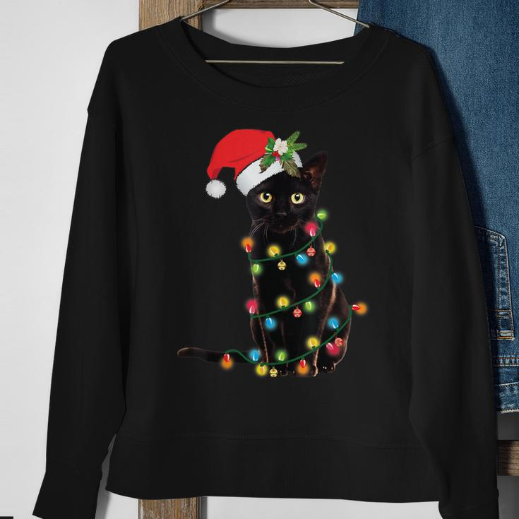 Santa Black Cat Tangled Up In Christmas Tree Lights Holiday Sweatshirt Gifts for Old Women